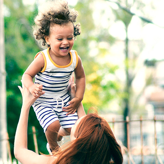 Mother lifting happy child