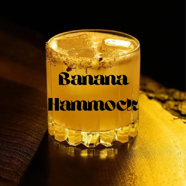 A glass of yellow cocktail with ice cubes on a dark surface, labeled "Banana Hammock.