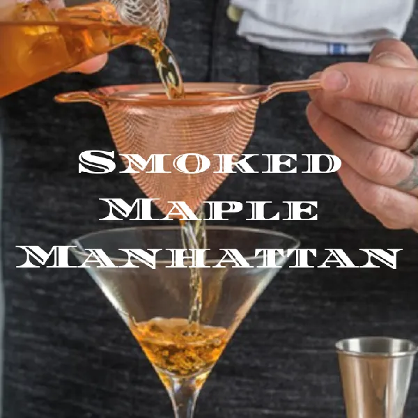 A person pours a cocktail through a strainer into a martini glass. The text "Smoked Maple Manhattan" appears over the image.