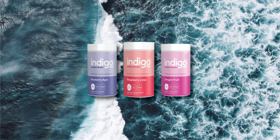 Three Indigo Metabolic Reset supplement containers—Blueberry Acai, Raspberry Lime, and Dragon Fruit—are displayed against an aerial view of ocean waves.
