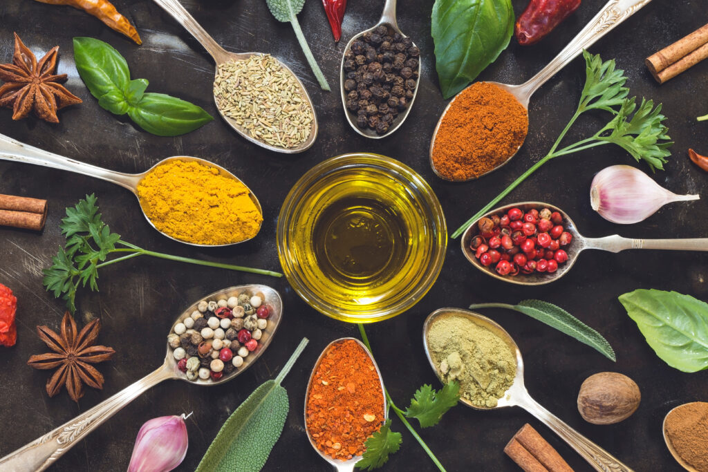 Various herbs and spices on black background